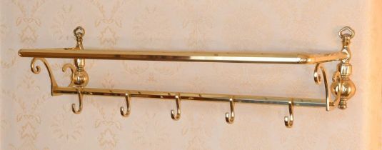 A 20th Century Brass Wall Shelf, with baluster and scrolled brackets and coat hooks 78cm wide Two