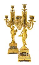 A Pair of French Gilt Metal and Champlevé Enamel Five-Light Candelabra, in Louis XVI style, with urn