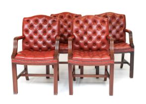 Wade Upholstery: A Set of Four Buttoned Red Leather Library Armchairs, 20th century, the reeded