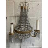 A Set of Three Regency Style Gilt Metal and Glass Twin-Branch Wall Lights, of bag shape, with reeded
