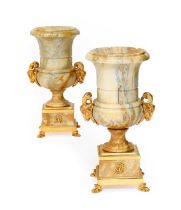 A Pair of Gilt Metal Mounted Veined Marble Campana Vases, modern, with ram's mask handles, on square