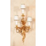 A Set of Nine Gilt Metal Three-Branch Wall Lights, in Louis XV style, the scroll cast sockets and