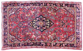 Sarouhk Rug West Iran, circa 1940 The strawberry field of flowers and plants centered by an indigo