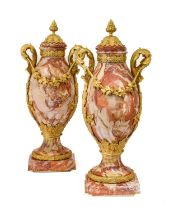 A Pair of French Gilt Metal Mounted Varigated Rouge Marble Urns and Covers, in Louis XVI style, of