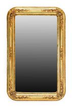 A Gilt and Gesso Bevelled Glass Mirror, circa 1870, the moulded frame surmounted by flowers and