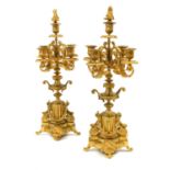 A Pair of Gilt Metal Five-Light Candelabra, in Louis XVI style, with floriform finials, fluted urn