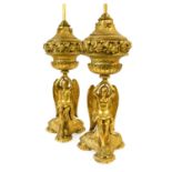 A Pair of Gilt Metal Figural Table Lamps, 20th century, each as a winged angel sitting on a carpet