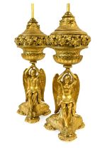 A Pair of Gilt Metal Figural Table Lamps, 20th century, each as a winged angel sitting on a carpet