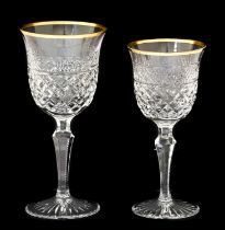 A Set of Twelve Wine Glasses, the bell shaped bowls with gilt line rims over bands of geometric