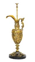 A Gilt Metal Ewer, in Renaissance style, with mermaid handle, cast with mythical figures, on a