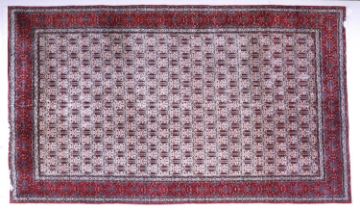Iranian Carpet, circa 1970 The ivory lattice field of boteh and flowers enclosed by a similar claret
