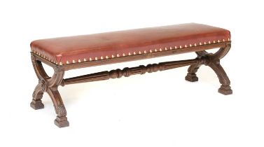 A Victorian Carved Oak Gothic-Style Large Dressing Stool, recovered in close-nailed brown leather,
