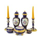 A Pair of Vienna Porcelain Candlesticks, 20th century, of baluster form, decorated with sprays of