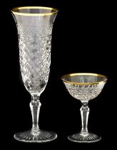 A Set of Twelve Champagne Flutes, en suite 25cm high Twelve Matching Liqueur Saucers 10cm high (