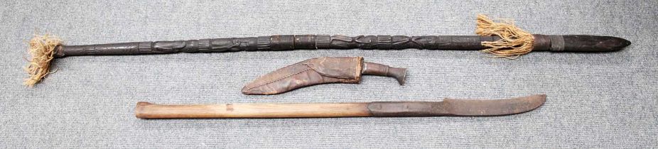 A Nepalese Kukri, the 30cm steel blade with two narrow fullers, with blade knopped wood grip and