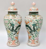 A Pair of Japanese Porcelain Covered Vases, Taisho period, painted in enamels with dragons amid