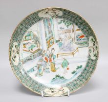 A Chinese Porcelain Saucer Dish, 18th century, painted in Famille Verte enamels with figures in an