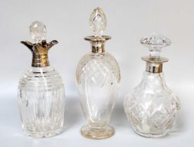 Three Silver Mounted Cut-Glass Decanters, one with a four-pour mount (3)