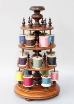 A Victorian Turned Mahogany Spool Holder, with turned finials and on compressed bun feet, 32cm One