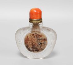 A Chinese Glass Snuff Bottle, with brass and coral stopper, carved with scrolled cartouches on a