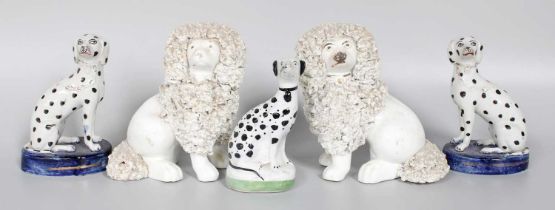 ~ A Pair of Staffordshire Seated Poodles, with textured clay, and three similar seated dalmations (