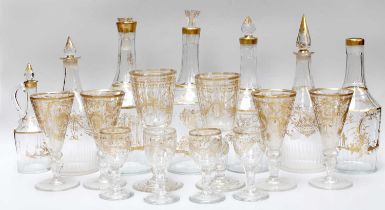 A Collection of Gilt Decorated Glassware, early 19th century, including seven decanters, a pair of