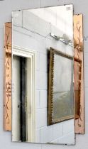 An Art Deco Frameless Mirror, with copper colouring, 59cm by 92cm