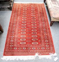 A "Bukhara" Rug, the chocolate field lattice field with columns of hooked guls enclosed by