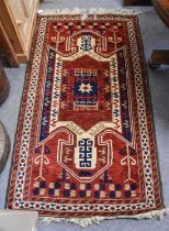 Kazakh Design Rug, the chestnut field with central shield enclosed by narrow ivory borders, 185cm by