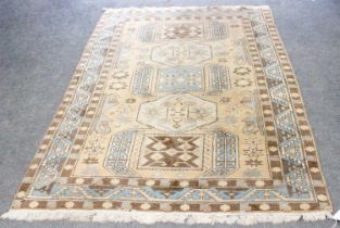 An Indian Rug, the field with a column of geometric panels enclosed by borders of geometric serrated