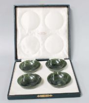 A Cased Set of Four Chinese Spinach Jade Bowls, of plain turned form, each 7cm diameter