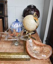 A Ruby Glass Mushroom Lamp, a modern world globe, and two art glass bowls, and a blue and white