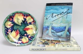 A Moorcroft Pottery Plate, "Leaves and Berries" pattern, impressed marks and signed, 26cm