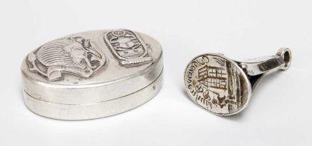 An Egyptian Silver Box, oval the cover applied with King Tutankhamun and a scarab beetle, 45mm wide;