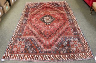 Kashgai Rug, the abrashed pale brick red field with stepped medallion enclosed by spandrels and
