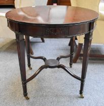 An Edwardian Circular Mahogany Plant Table, with fluted tapering square section supports joined by