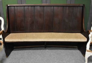 A 19th Century Stained Pitch Pine Settle, of curved form, 212cm by 52cm by 135cm