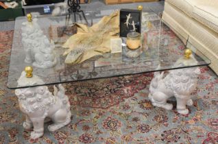 A Reproduction Glass Coffee Table, the legs in the form of Dogs of Fo, 122cm square by 44cm