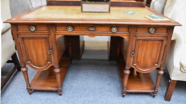 An Edwardian Leather-Inset Walnut Desk, 134cm by 72cm by 77cm