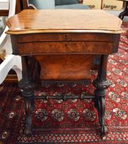 A Victorian Walnut Work Table, the hinged shaped top opening to reveal a lift up writing surface