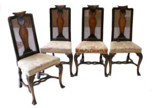 A Set of Four Early 20th Century Walnut and Cane-Back Dining Chairs, the scrolled top rails carved