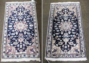 A Pair of Nain Rugs, each with flowerhead medallion framed by spandrels and narrow borders, (each