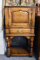 A Titchmarsh & Goodwin Oak Cabinet, the moulded panel door over a dressing slide above a single