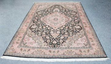 Kashmir Silk Piled Carpet, the charcoal field of vines centered by a candy pink medallion framed