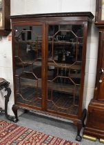 A George III Mahogany Bookcase, with two astragal glazed doors, on ball and claw feet, 119cm by 40cm