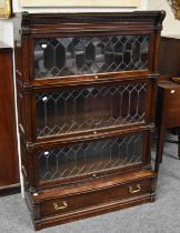 A 1920's Globe Wernicke Oak Three-Tier Stacking Bookcase, with dentil cornice,fluted supports and