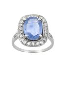 A Sapphire and Diamond Cluster Ring the oval cut sapphire within a border of old cut and eight-cut