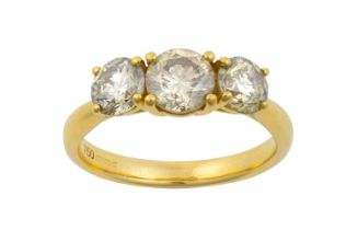 An 18 Carat Gold Diamond Three Stone Ring the graduated round brilliant cut diamonds in yellow