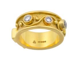 An 18 Carat Gold Diamond Ring the yellow textured band inset with four vari-sized round brilliant