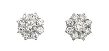 A Pair of Diamond Cluster Earrings the central raised round brilliant cut diamond within a border of